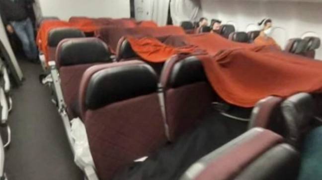 Cabin crew were forced to sleep under makeshift blanket forts. Credit: Nine News