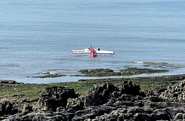 Witnesses to the crash said the pilot had a 'very near miss' after they narrowly avoided crashing onto the rocks. Credit: PA 