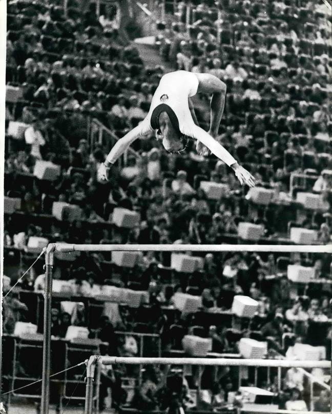 Olga Korbut performing the now banned 'dead loop', which involves doing a backflip off the top bar and grabbing onto it. Credit: Keystone Press / Alamy Stock Photo