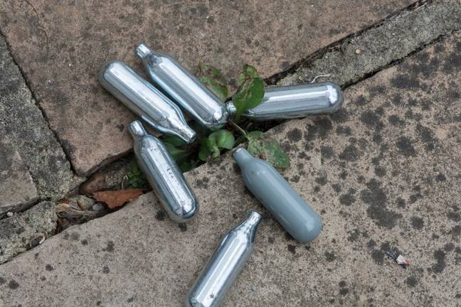 Nitrous Oxide canisters. Credit: adrian davies / Alamy Stock Photo