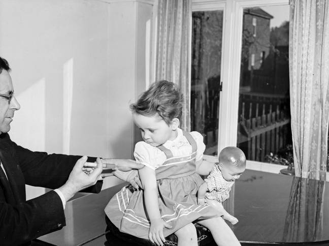 A child receives a polio vaccine in 1959. Credit: Mirrorpix/Getty 