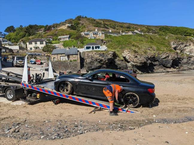 The BMW had to be pulled out of the sea. Credit: Facebook/St Agnes Coastguard Search and Rescue