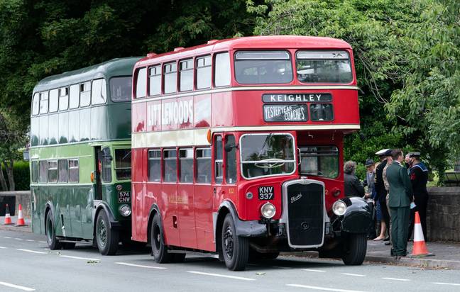 The guard of honour arrived on two vintage buses. Credit: PA