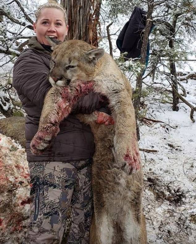 Esplin with the dead mountain lion. Credit: Facebook