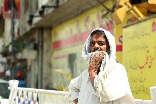 A man covers his head with a piece of cloth during a heatwave in Rawalpindi, Pakistan, on June 29, 2019. Credit: PA