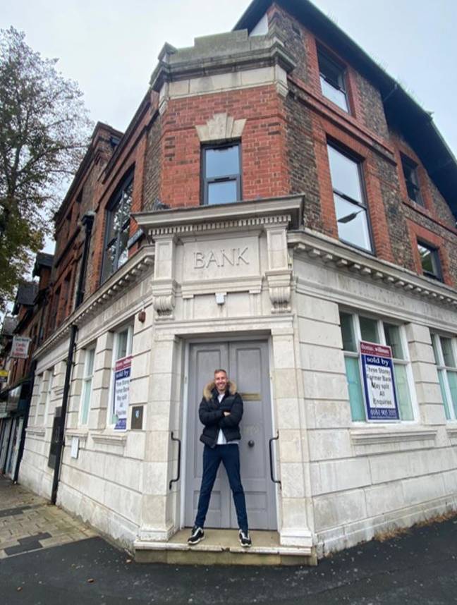 Adam outside the bank building where he was once rejected for a business loan. Credit: Adam Deering