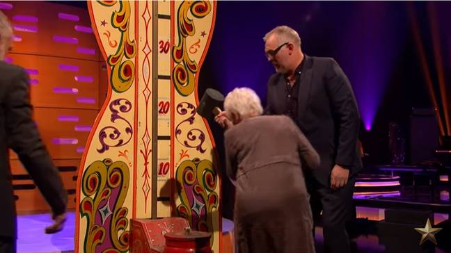 Dame Judi Dench gives the hammer challenge a go. Credit: BBC/The Graham Norton Show