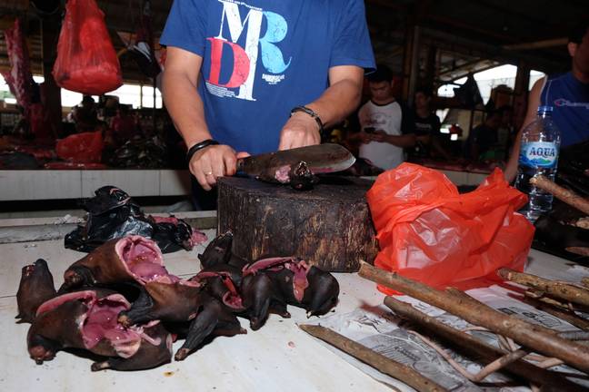 Traders selling bat meat. Credit: PA