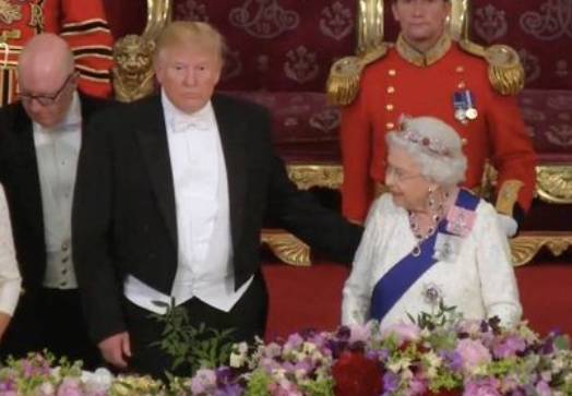 The US president appeared to reach across and touch the Queen's back. Credit: Sky News
