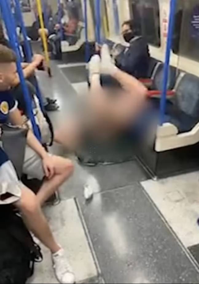 A Scottish fan performs the worm on the London Underground.