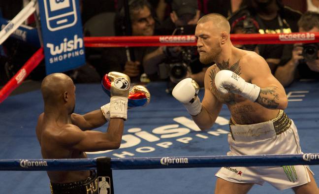 Conor McGregor in the boxing ring against Floyd Mayweather. Credit: PA