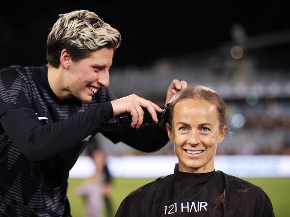 Aivi Luik gets her head shaved by Rebekah Scott. Credit: Getty Images