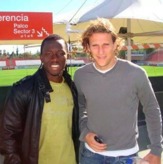 Sadick Adams with Diego Forlan during his days at Atletico Madrid.