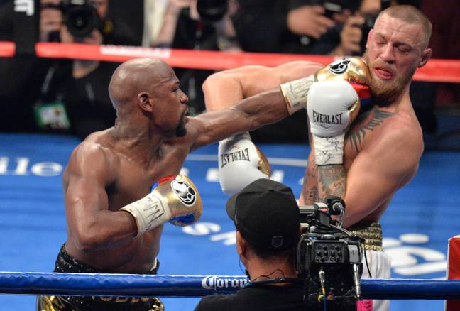 Mayweather lands a punch on McGregor during their 2017 boxing bout. Image: PA