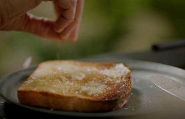 The telly cook then butters the toast for a second time using unsalted butter - and adds a sprinkling of sea salt flakes (Credit: BBC2)