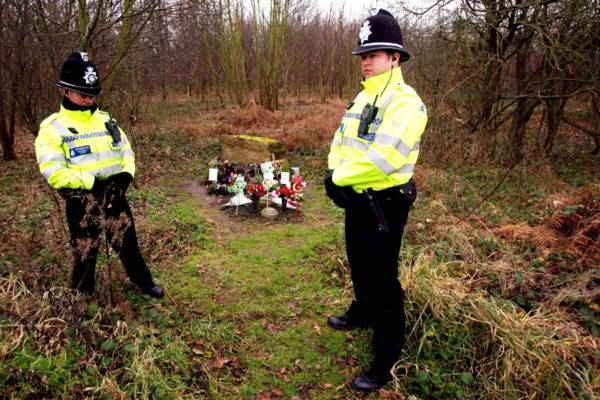 Police officers stand near tributes left for Paula Clennell at Levington. (Credit: PA)