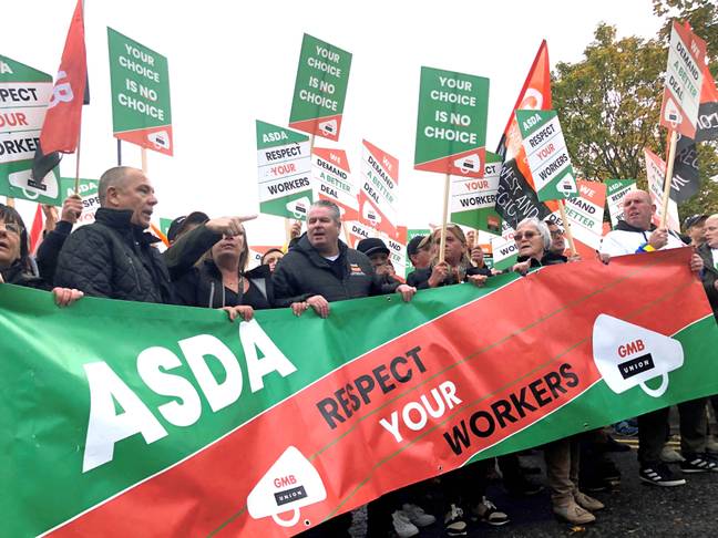 ASDA have received backlash following news of a contract they are asking employees to sign. Pictured, workers marching in October opposing the new contract (Credit: PA)