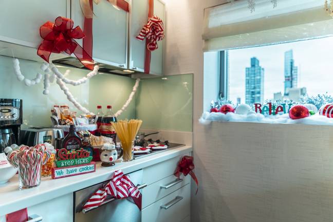 In the kitchen, ribbons cover the cabinets and a full-size fridge is stocked with elves' four essential food groups. (Credit: Club Wyndham)