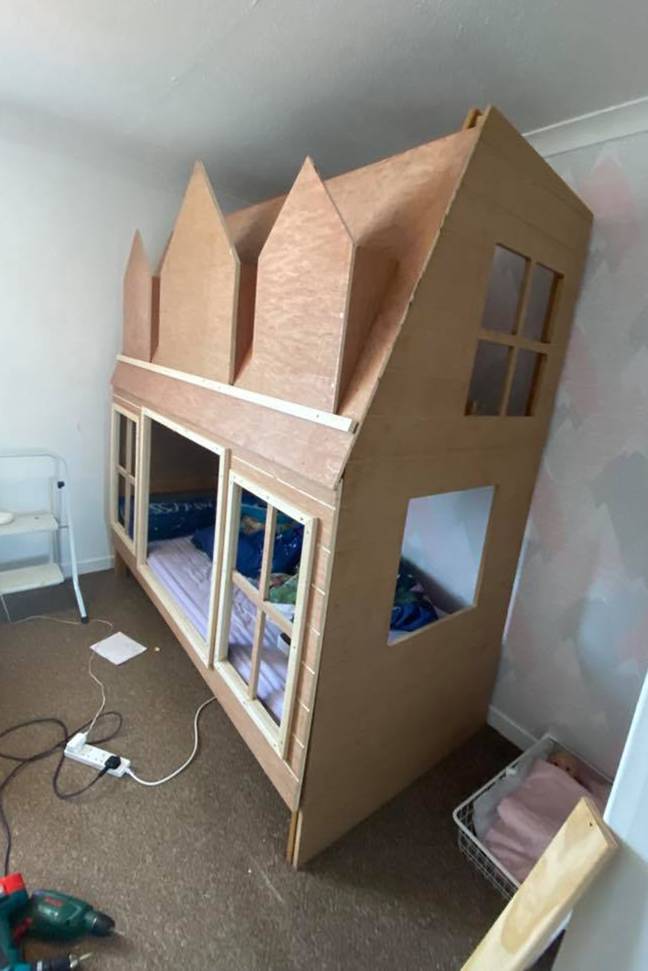 The couple used spare wood and a bed frame they already owned to create the doll's house design (Credit: Caters)