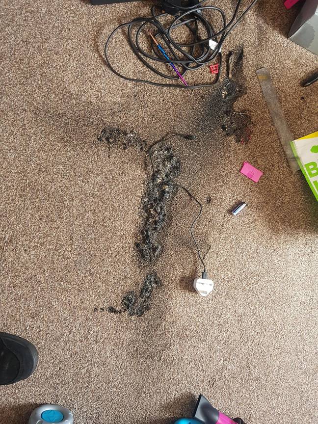 The e-cig charger had burnt a hole in the carpet and filled the room with smoke (Credit: Caters)
