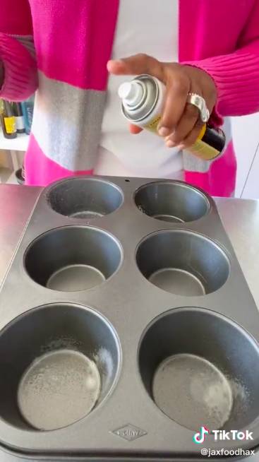 Grease the muffin tin compartments with a quick spritz of oil (Credit: TikTok / @JaxFoodHax)