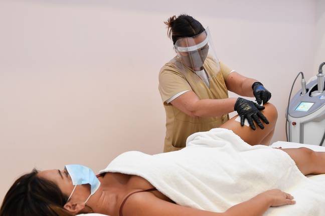 A sign of things to come? Over in Italy, beauty salons are already reopening with staff required to wear visors and customers wearing masks (Credit: Shutterstock)