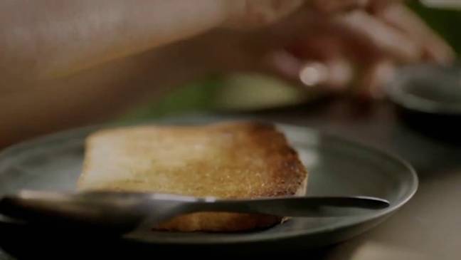 First, Nigella takes a piece of toast that has been buttered straight from the toaster (Credit: BBC2)
