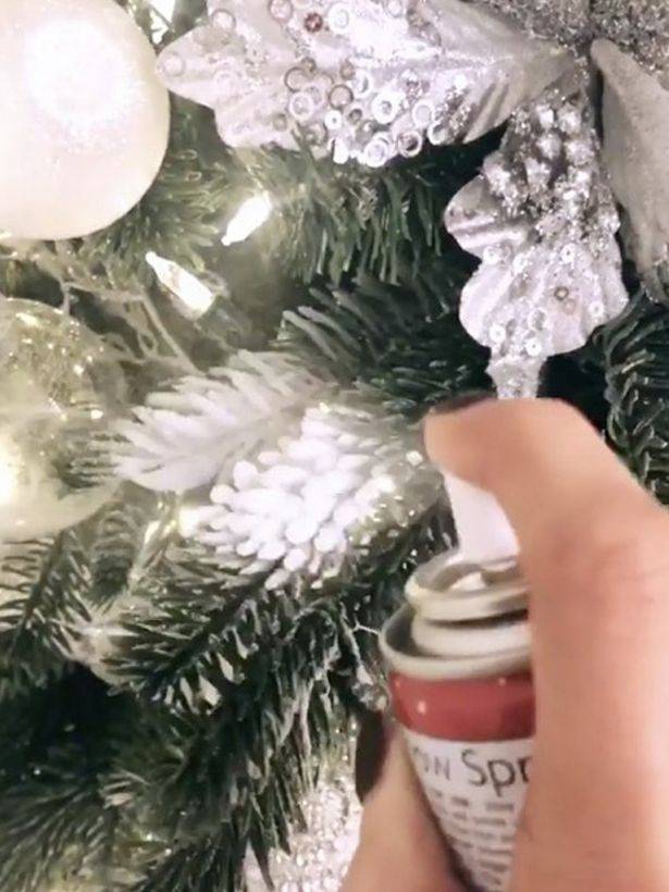 To neaten the tree up Mrs Hinch sprays the bauble strings with fake snow. (Credit: Instagram/Mrs Hinch)