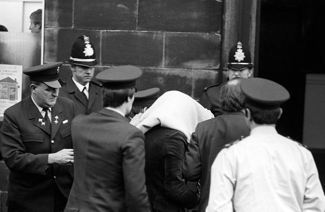 Peter Sutcliffe, under a blanket, arriving at Dewsbury Magistrates Court. (Credit: PA)