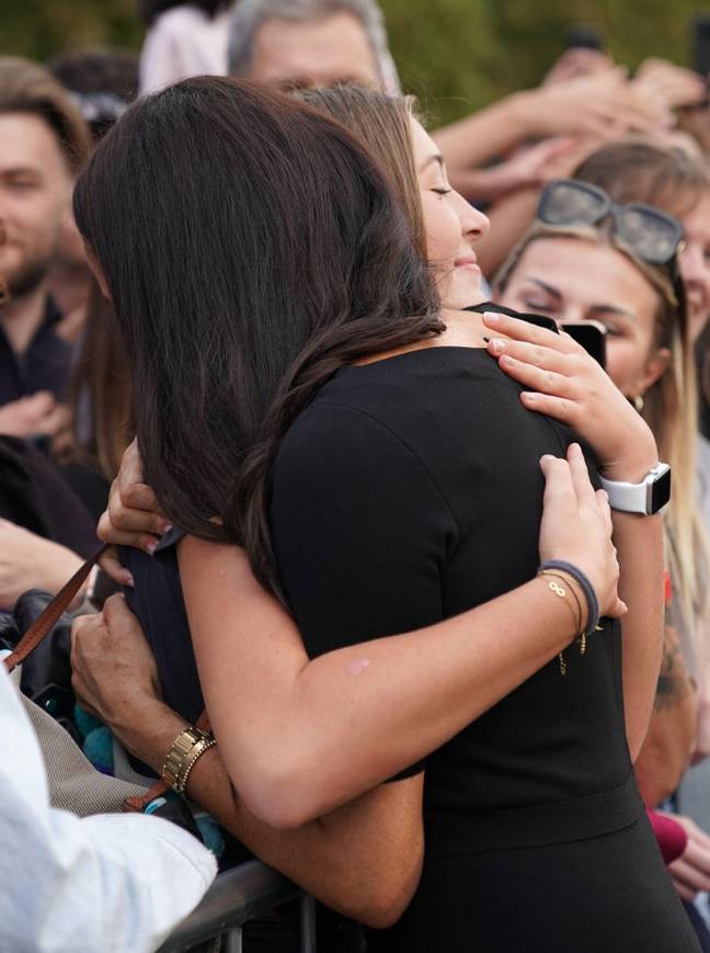 Meghan Markle hugged a young mourner outside Windsor Castle. Credit: PA Images/Alamy Stock Photo.