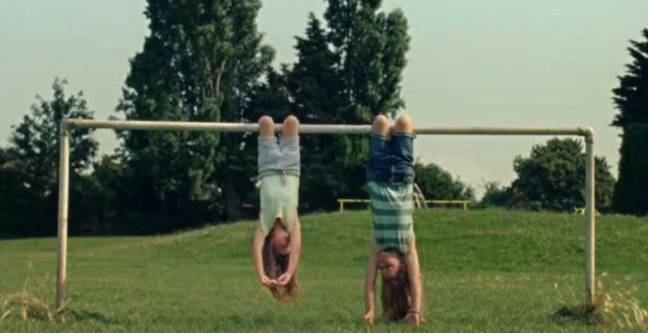 The advert featured two girls hanging upside down (Credit: Mondelez)