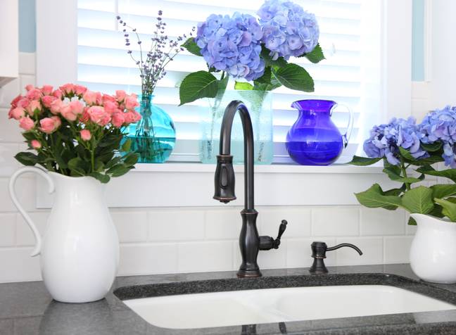 Have you ever wondered why kitchen sinks always seem to be underneath a window? (Credit: Alamy)