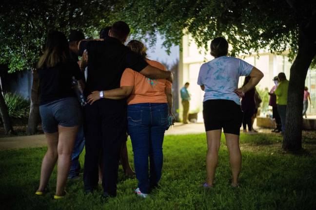 Families gathered outside the school and awaited news of missing relatives. Credit: Alamy