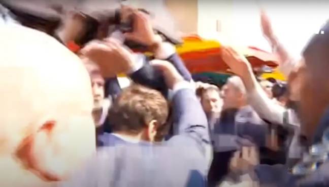 Emmanuel Macron's team shielded him from the tomatoes (Credit: pablo geneva/YouTube)