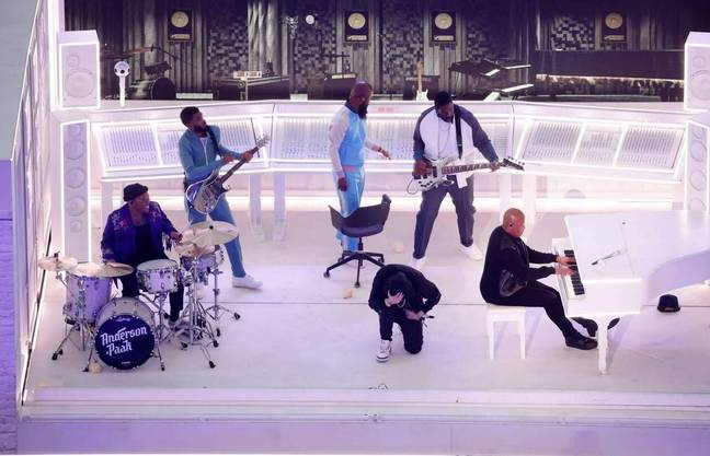 Eminem kneeling onstage at Super Bowl (Alamy)