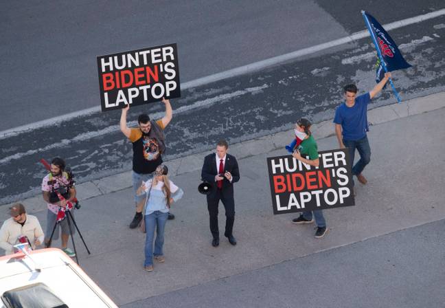 Trump supporters with 'Hunter Biden laptop' signs. (Alamy)