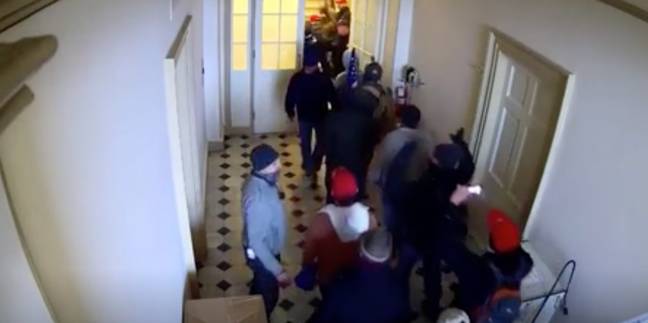 The moment the officers appeared to open the doors and wave in the protestors. Credit: Department of Justice