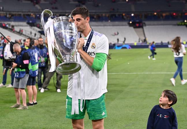 Courtois celebrates with the trophy. Image: PA Images