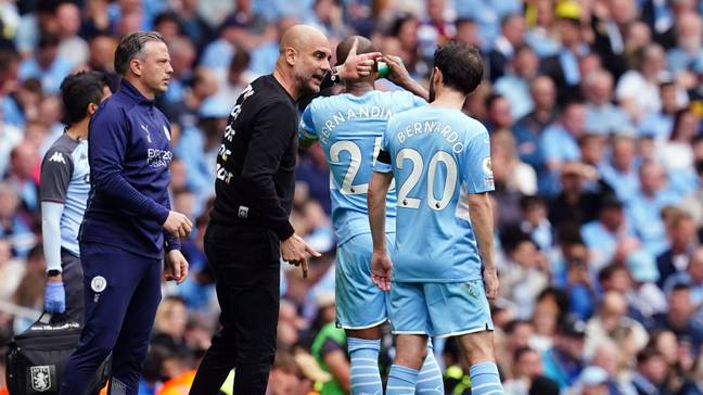 Pep Guardiola offers instructions to Bernardo Silva in Manchester City action.
