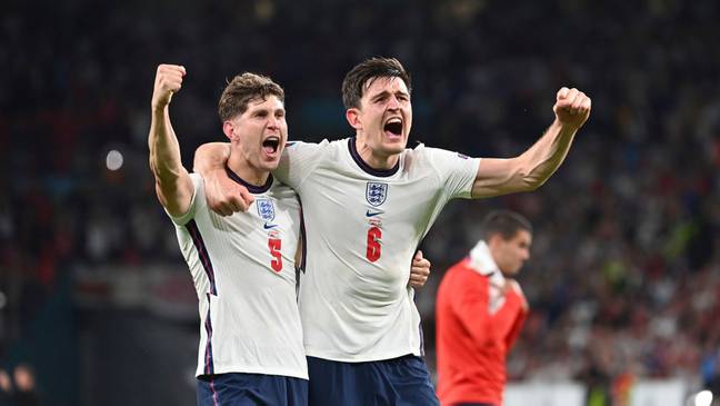 John Stones and Harry Maguire celebrate winning the EURO 2020 semi-final against Denmark