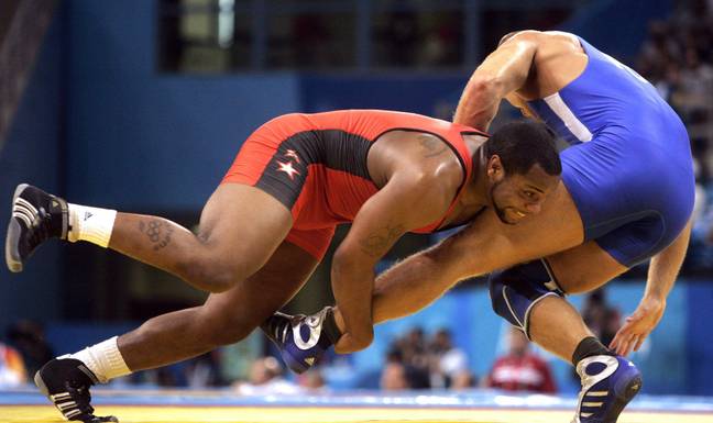 Daniel Cormier battles Bartlomiej Bartnicki of Poland in the freestyle wrestling 96kg class on Saturday, August 28, 2004. Image credit: Alamy