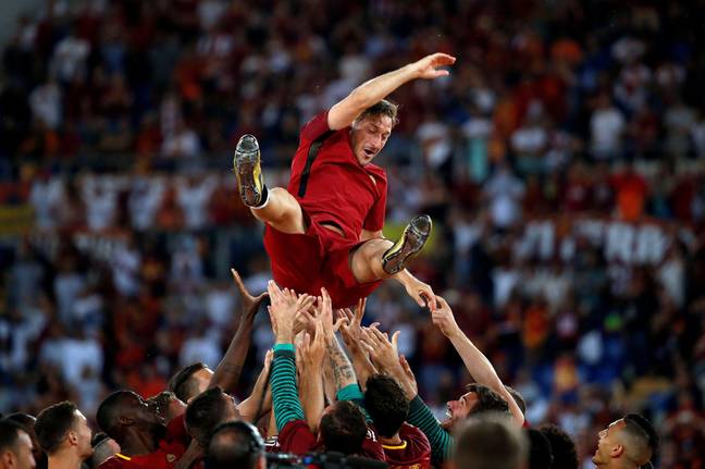 Totti being given a farewell by his teammates. Image: PA Images
