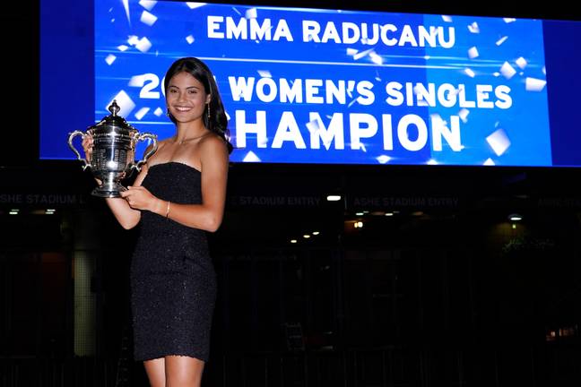 Raducanu poses with her first ever senior trophy outside Arthur Ashe Stadium after the dust settled on her historic win. Image: PA Images