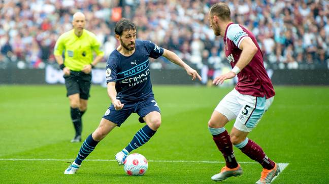 Bernardo Silva of Manchester City with the ball as Vladimir Coufal of West Ham challenges during the Premier League match at the London Stadium.