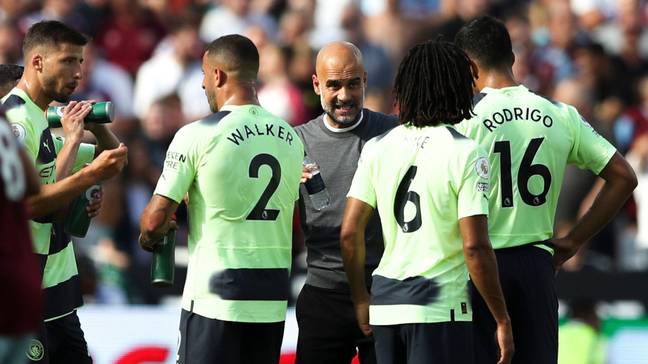 Pep Guardiola's briefs his Manchester City players.