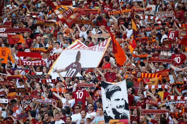 Fans with scarves, pictures and signs all dedicated to Totti. Image: PA Images