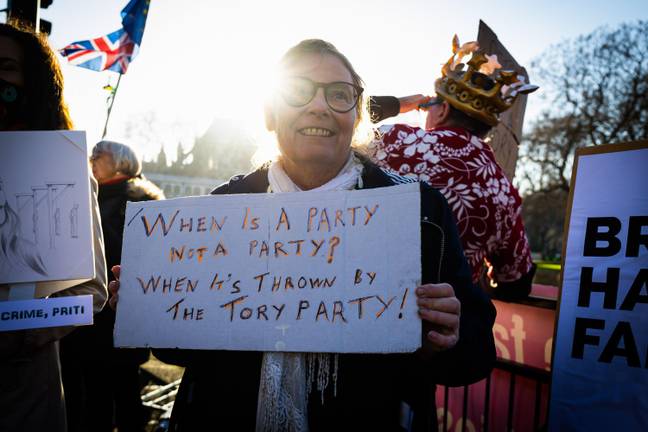 A protester holding a sign about the Number 10 party in May 2020. Credit: ZUMA Press Inc/Alamy Stock Photo