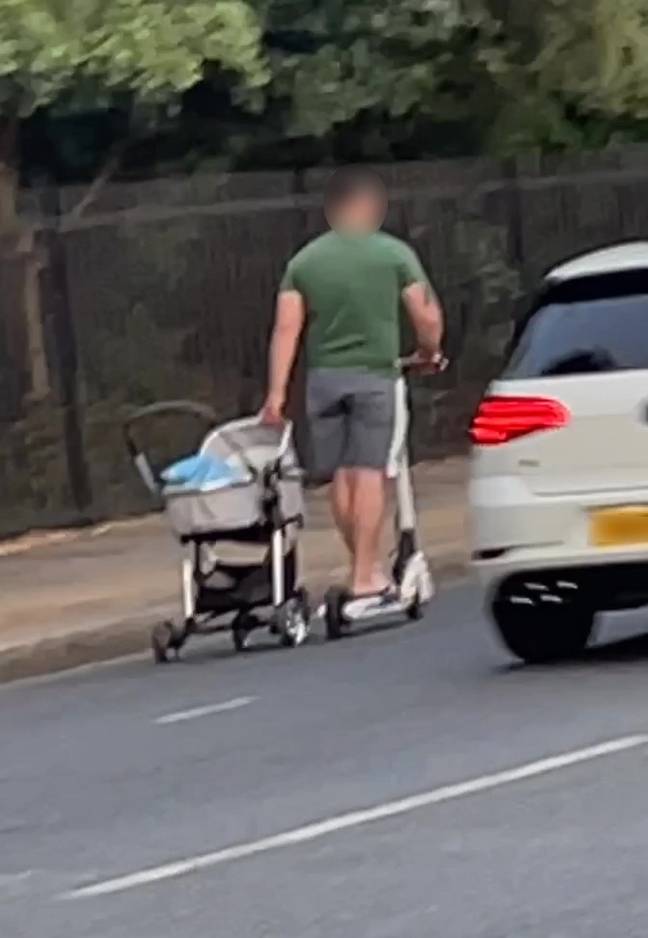 Cars brushed close past the man and his pram. Credit: Kennedy News &amp; Media