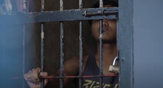 An inmate behind bars at Kerobokan prison, Bali. Credit: ABC News