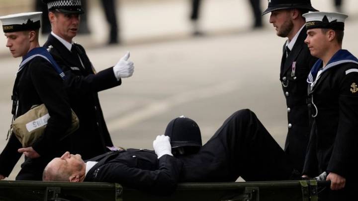 Police officer carried away on stretcher after collapsing during Queen's funeral